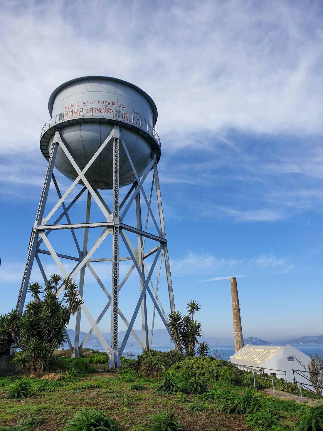 A steel water tower against a blue sky